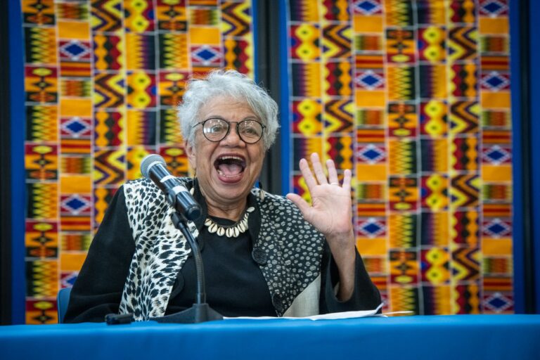 Anita White Carter smiles and waves at the camera